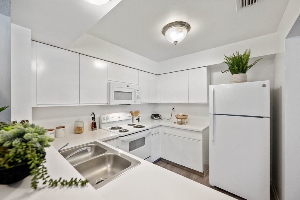 the preserve at ballantyne commons apartment kitchen with white cabinets and stainless steel appliances