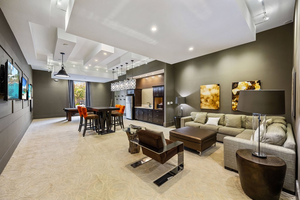 a living room with a couch and a table and a kitchen