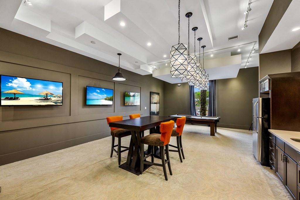a kitchen and dining room with a table and chairs and a television