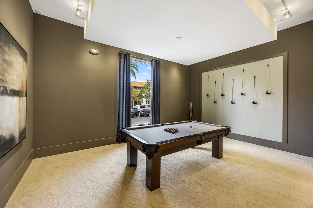 a games room with a pool table and a door to the street