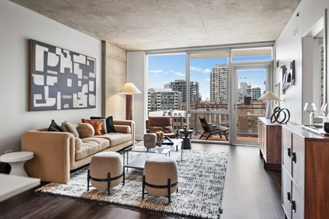 A modern living room with a large window overlooking the city.