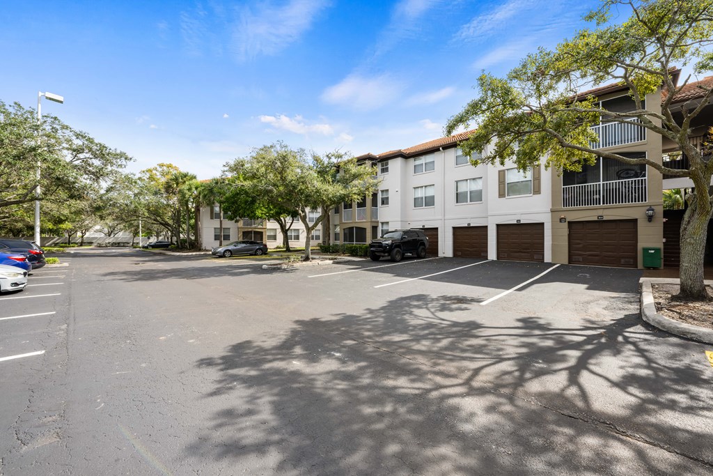 an empty parking lot in front of an apartment building