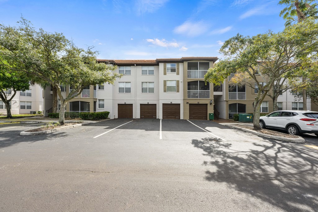 an empty parking lot in front of an apartment building
