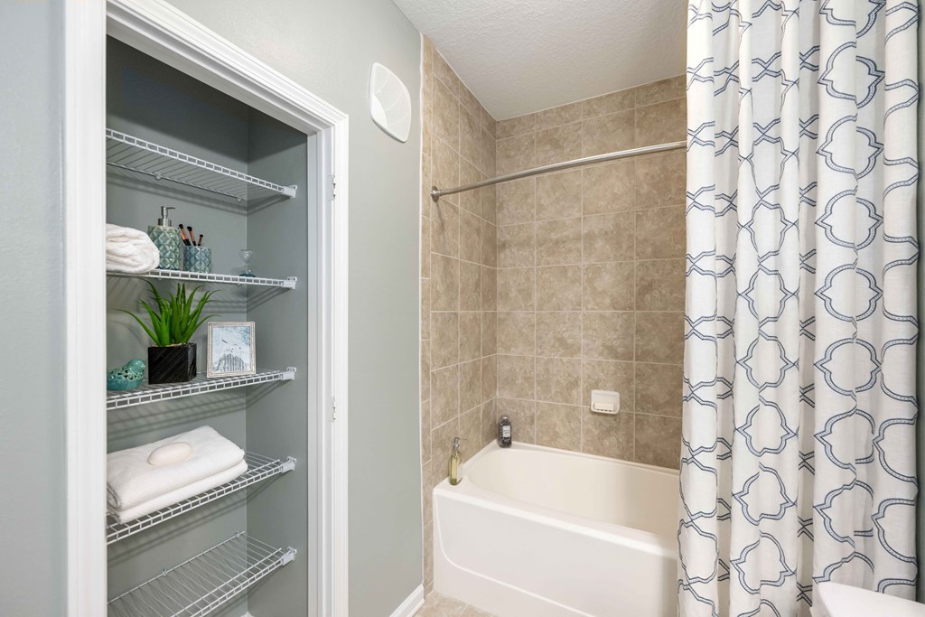 a bathroom with a bathtub and a shower with a curtain