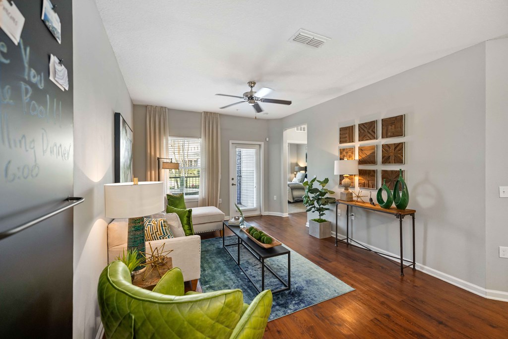 a living room with gray walls and a ceiling fan