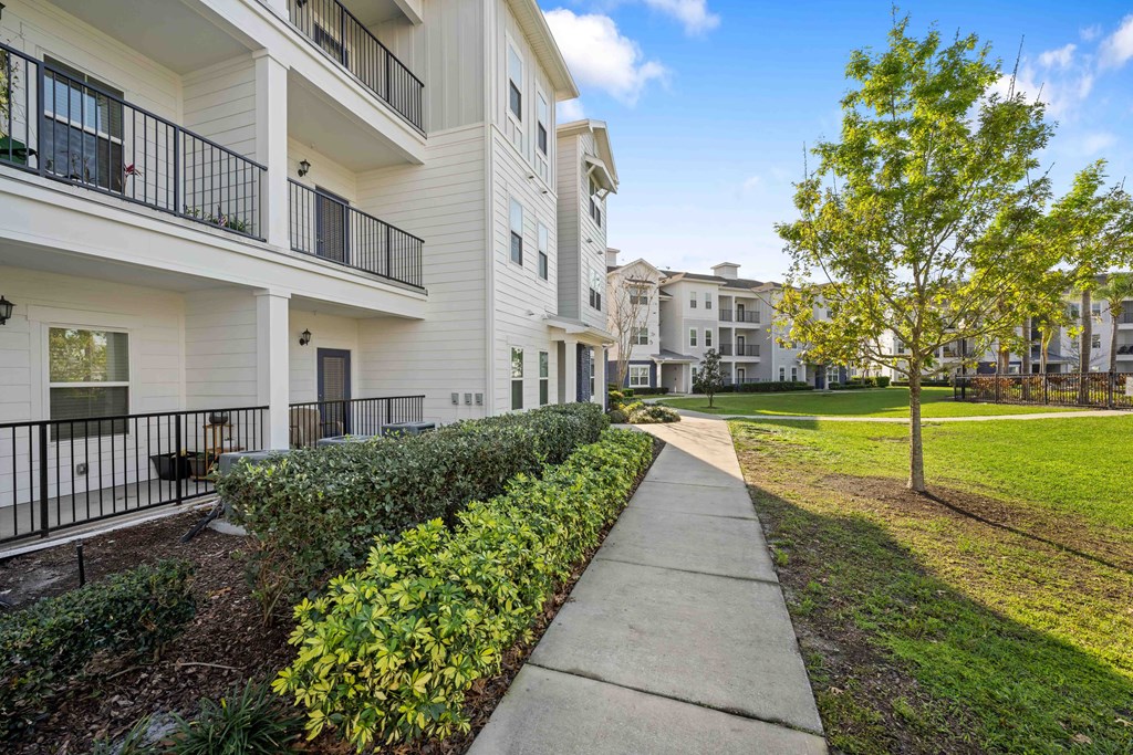 walkway and grassy area at the bradley braddock road station apartments