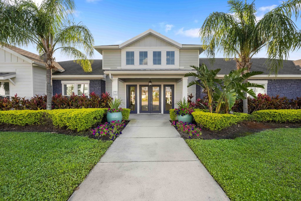 a large house with a sidewalk in front of it