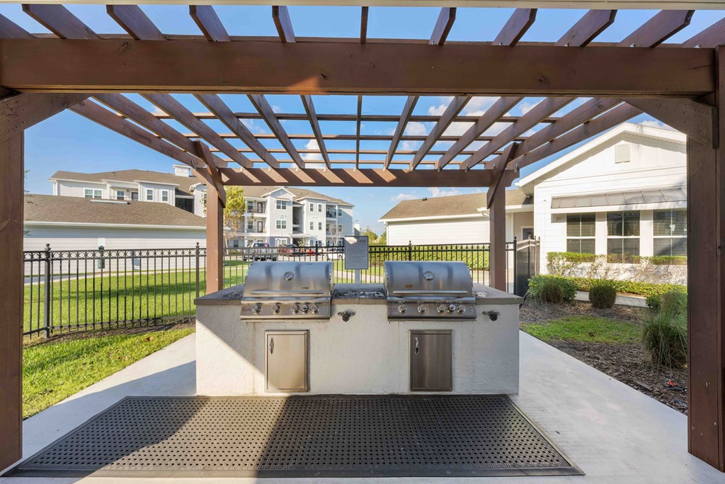 an outdoor kitchen with a pergola