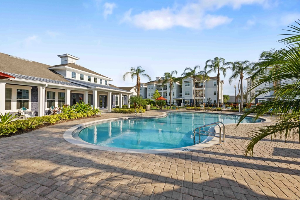 a large swimming pool in front of a building