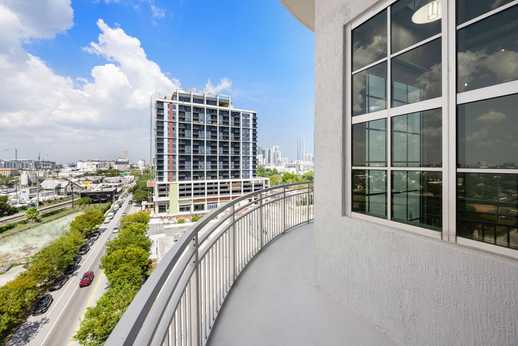 a balcony with a view of a city
