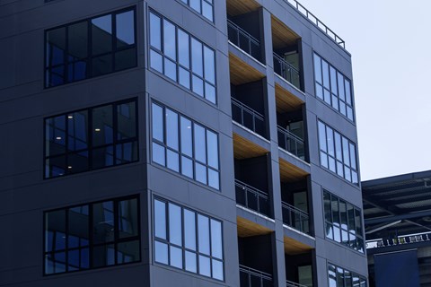 A tall building with many windows and balconies.