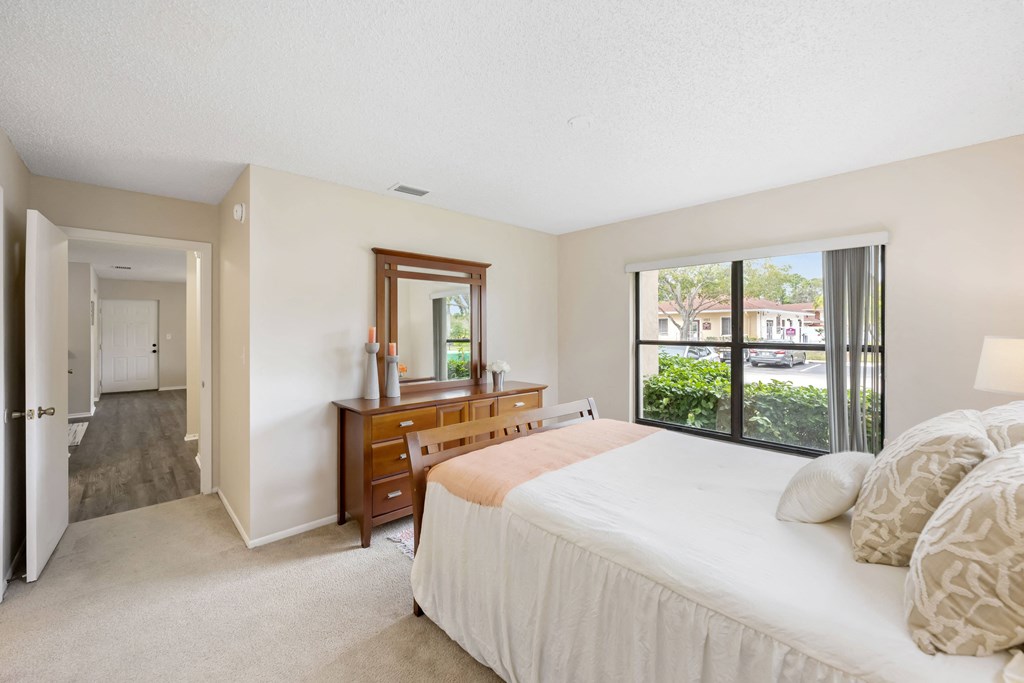 a bedroom with a large bed and a large window