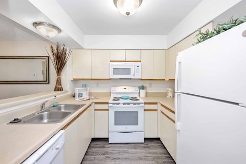 a kitchen with white appliances and a sink