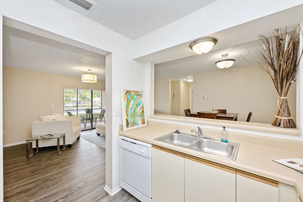 a kitchen with white cabinetry and a white dishwasher