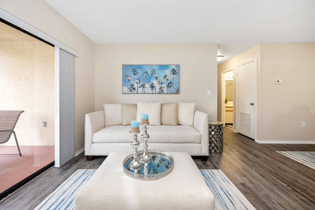 a living room with a white couch and coffee table