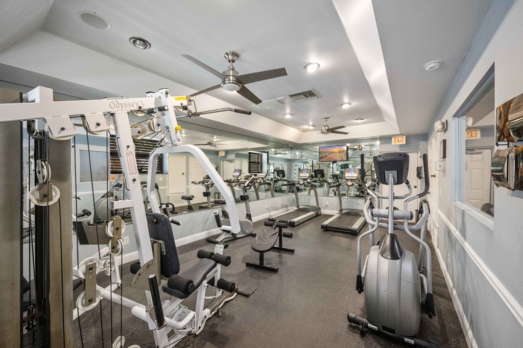 gym with cardio equipment at the whispering winds apartments in pearland, tx