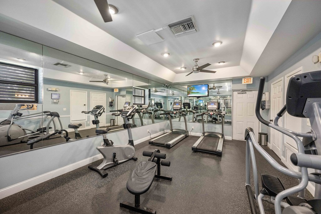 our apartments showcase a large fitness center with a treadmill and elliptical machines