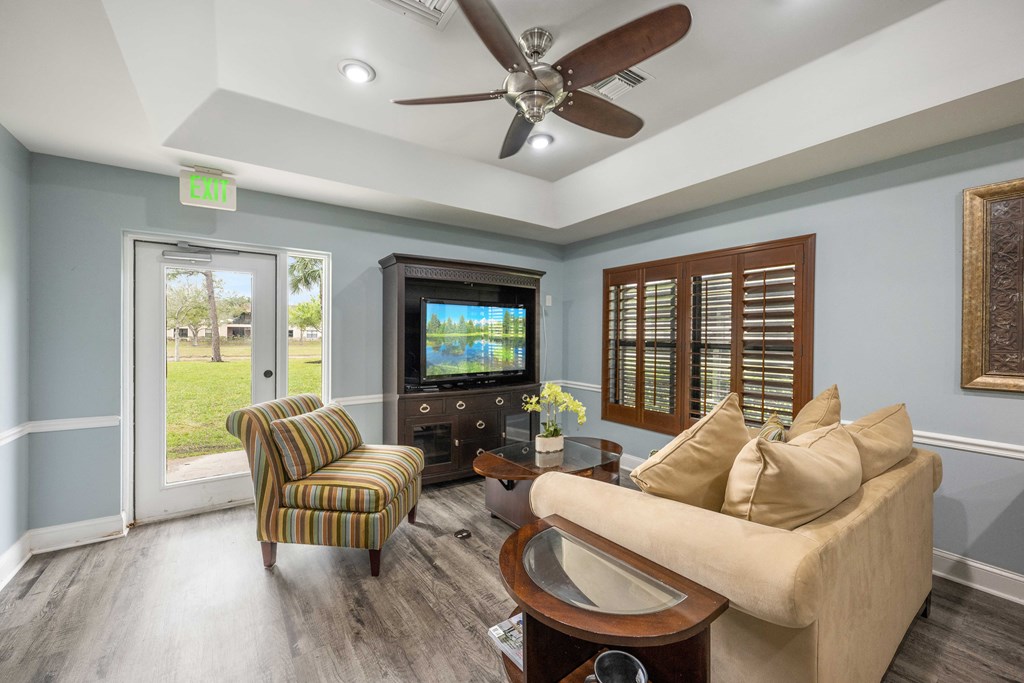 a living room filled with furniture and a flat screen tv