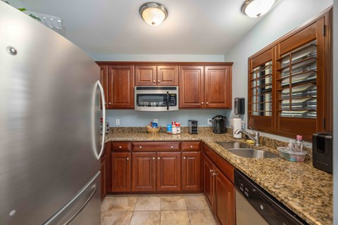 full kitchen with stainless steel appliances and granite counter tops