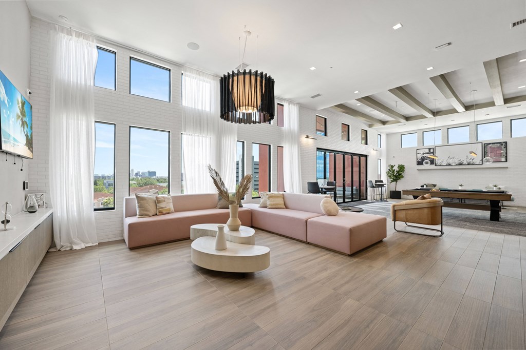 a living room with a pink couch and a coffee table