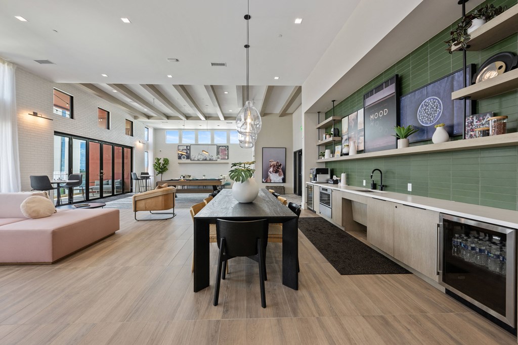 a dining room and living room with a black table