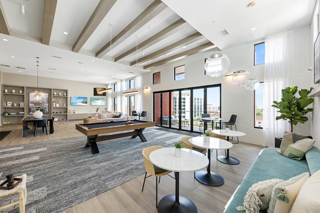 a living room with a pool table and couches