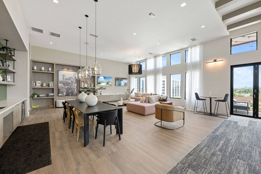 a living room and dining room with a table and chairs