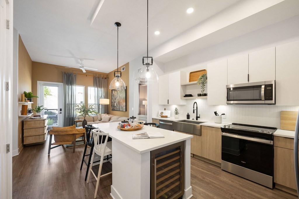 a kitchen and living room with an island and a dining table
