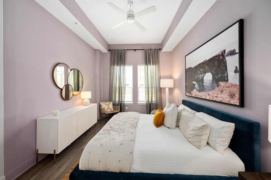 a bedroom with pink walls and a large bed