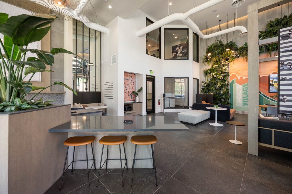 a lobby with a table and three stools