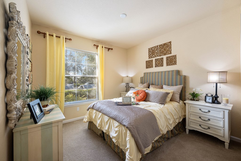 A queen sized bed in a spacious bedroom