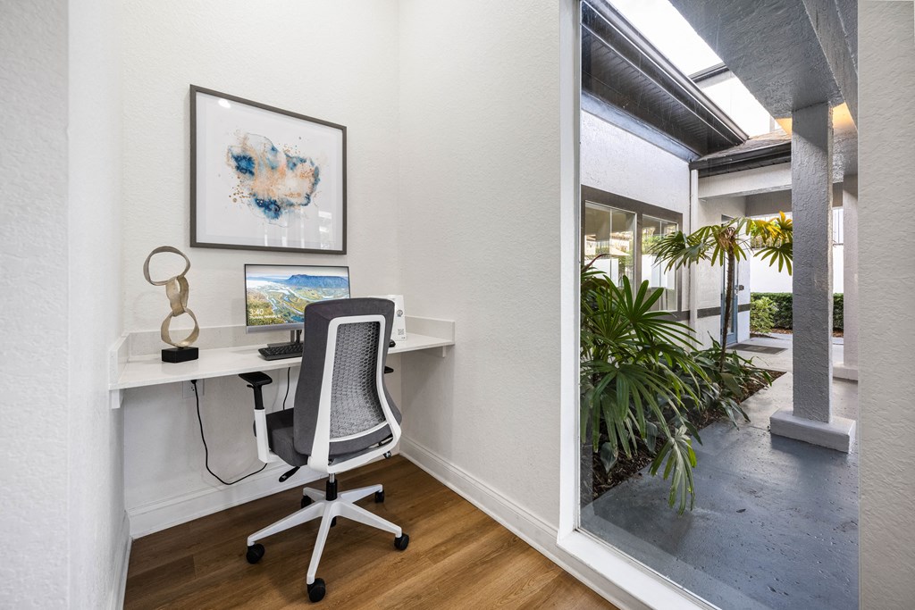 a home office with a desk and a window