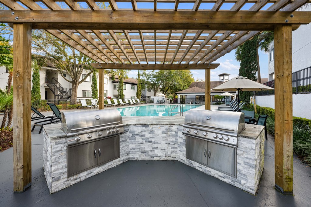 A set of grills overlooking the outdoor pool
