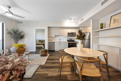 A modern kitchen with a dining table and chairs.