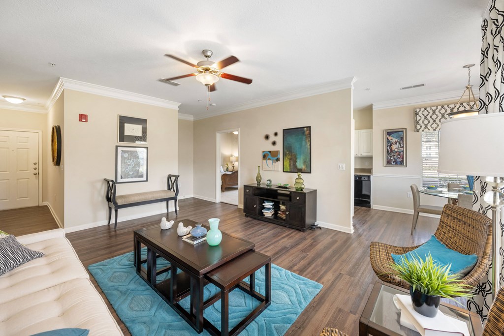 a living room with a ceiling fan and a table
