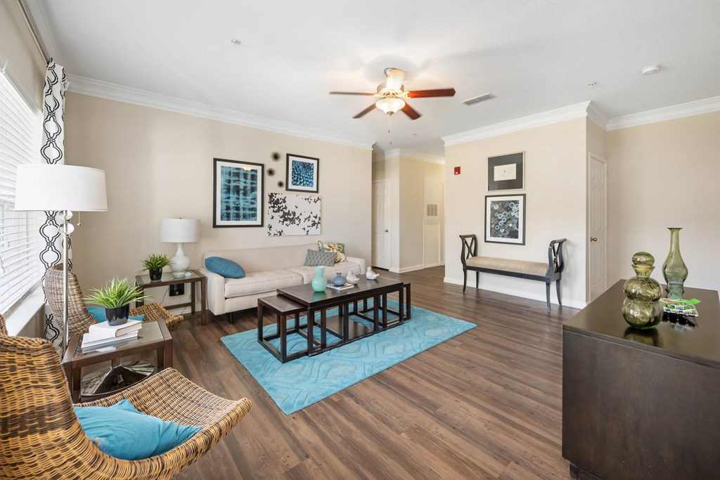 a living room with furniture and a ceiling fan