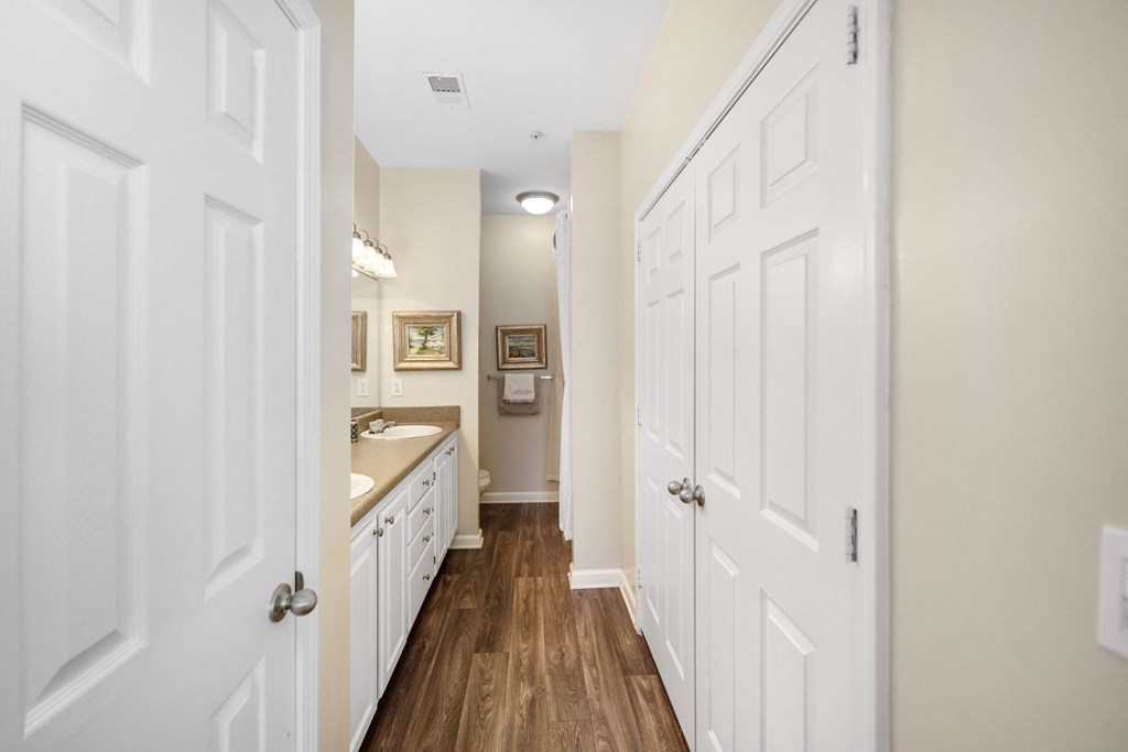 a bathroom with white cabinets and a sink and a mirror