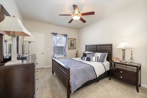 a bedroom with a bed and a ceiling fan