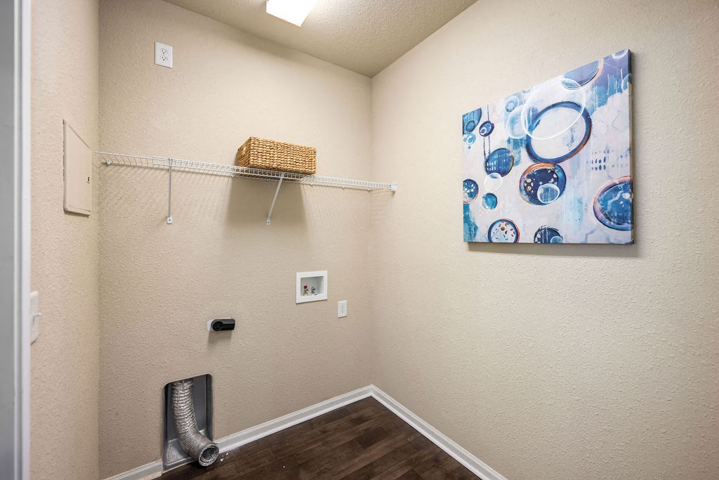 A room with a basket on a shelf and a painting on the wall.