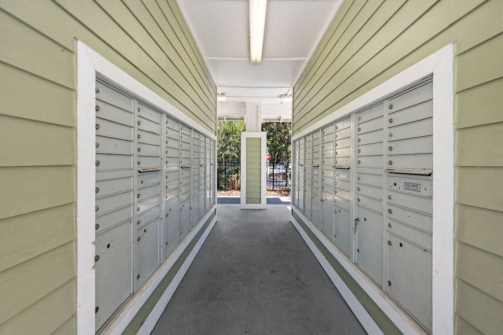 A long hallway with mailboxes on both sides.
