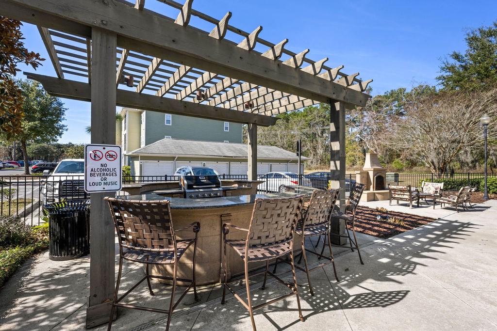 A patio area with chairs and a sign that says