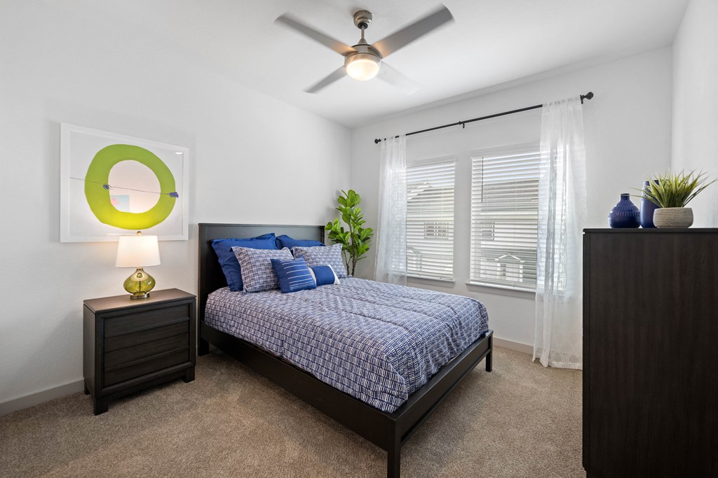 furnished bedroom with ceiling fan and window at the preserve at greatstone