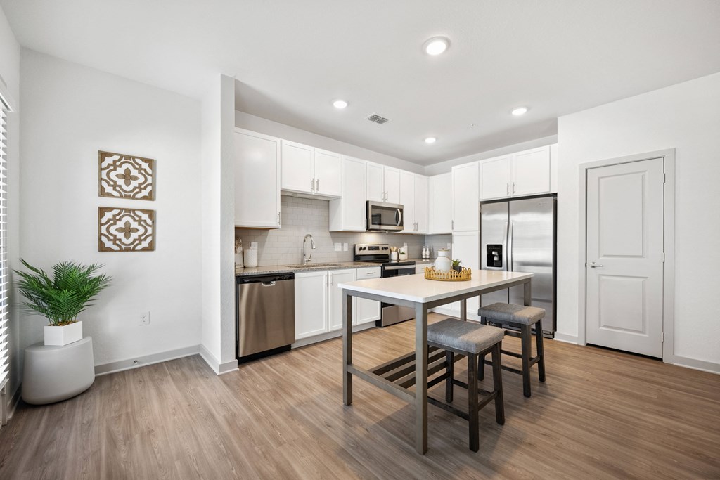 an open kitchen and dining area with a table and chairs