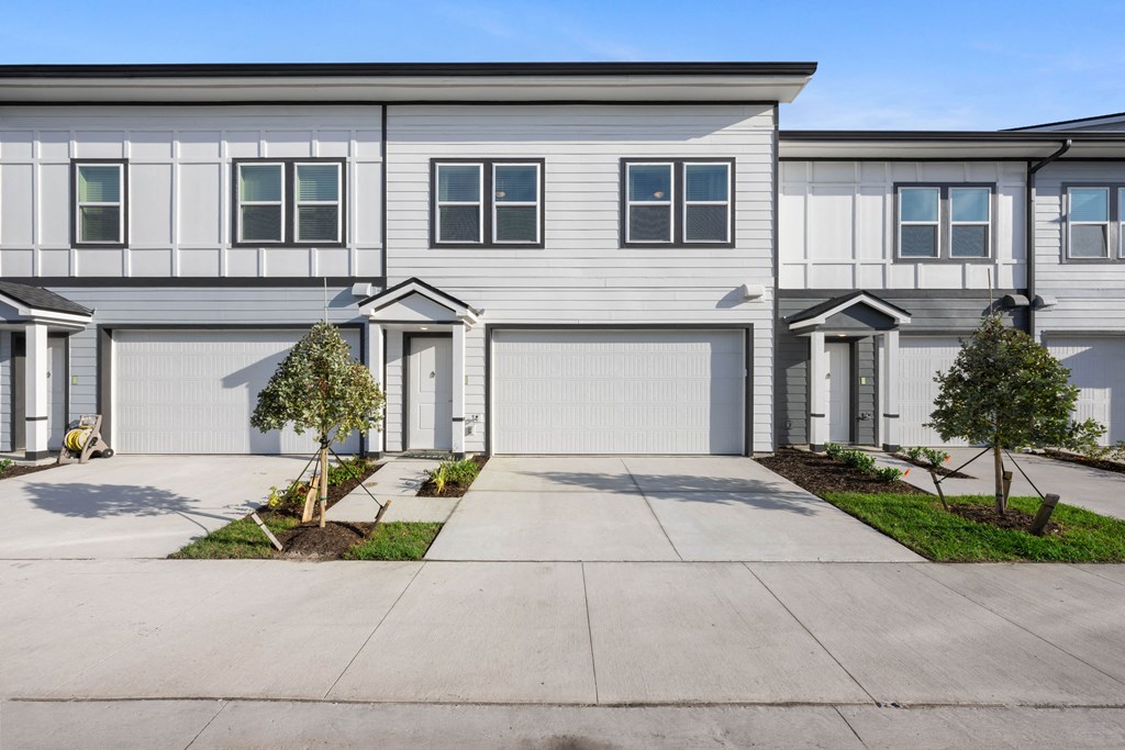 a white house with a garage door in front of it
