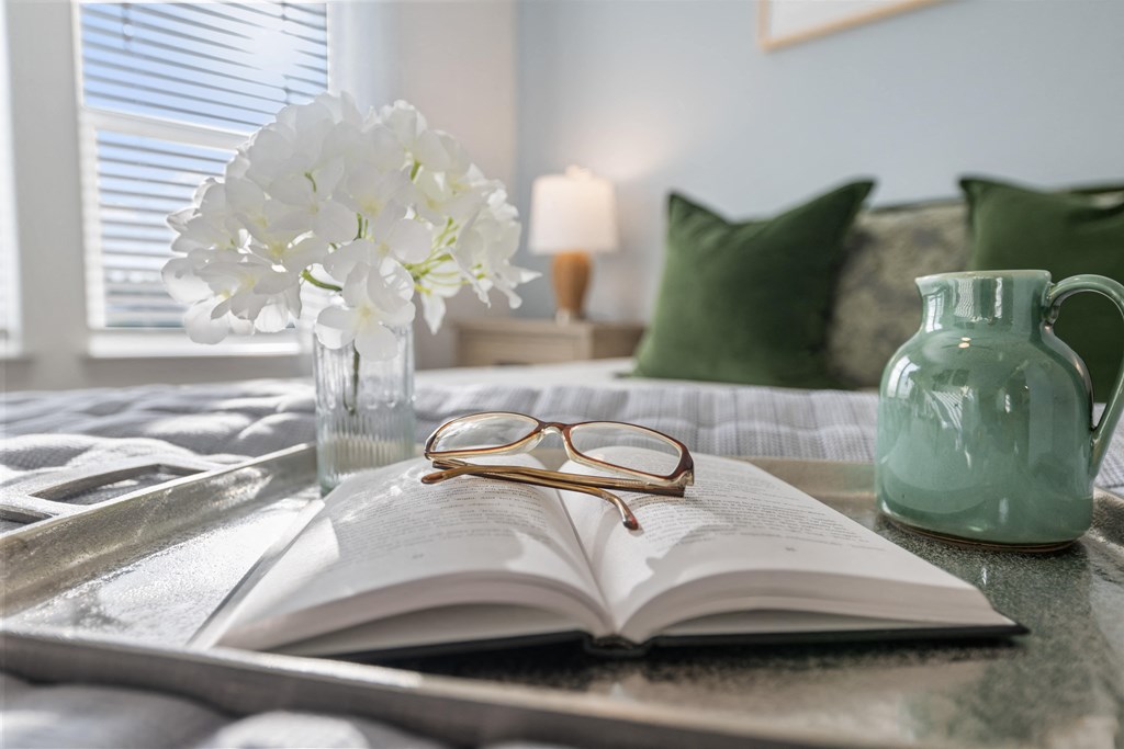 a book on a table with glasses on top of it