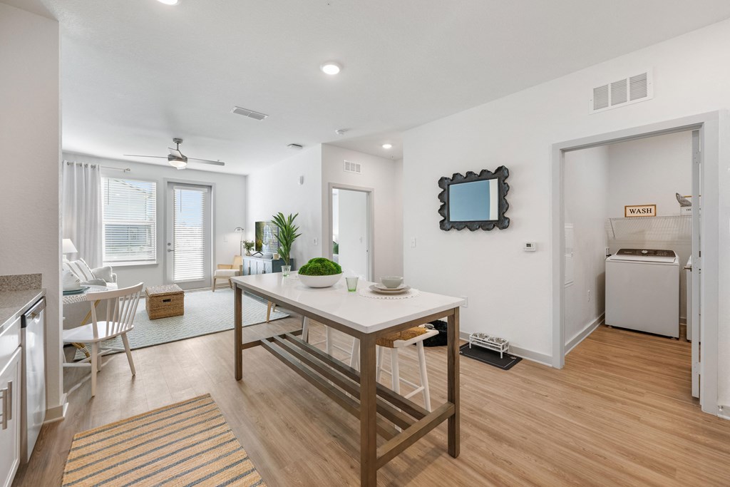 an open living room with a dining room table and a kitchen