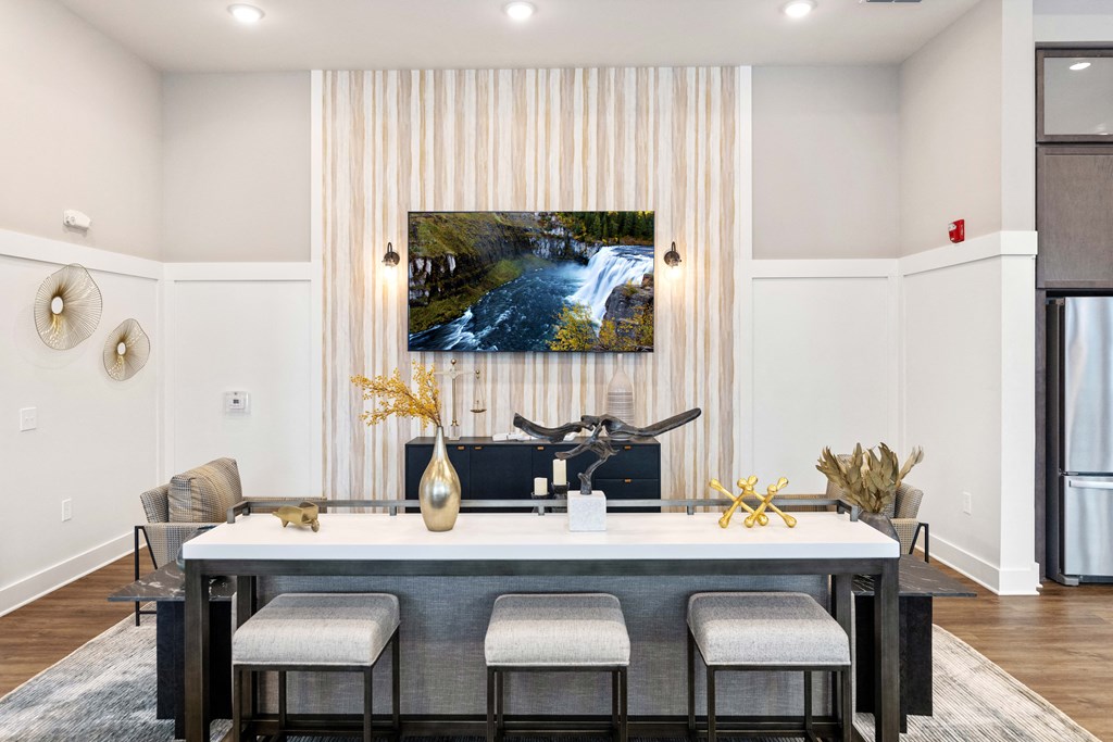 a dining room with a table and chairs and a painting on the wall