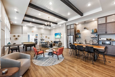 a clubhouse with a dining area and a kitchen with a table and chairs