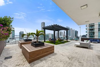 a large terrace with a seating area and a pergola