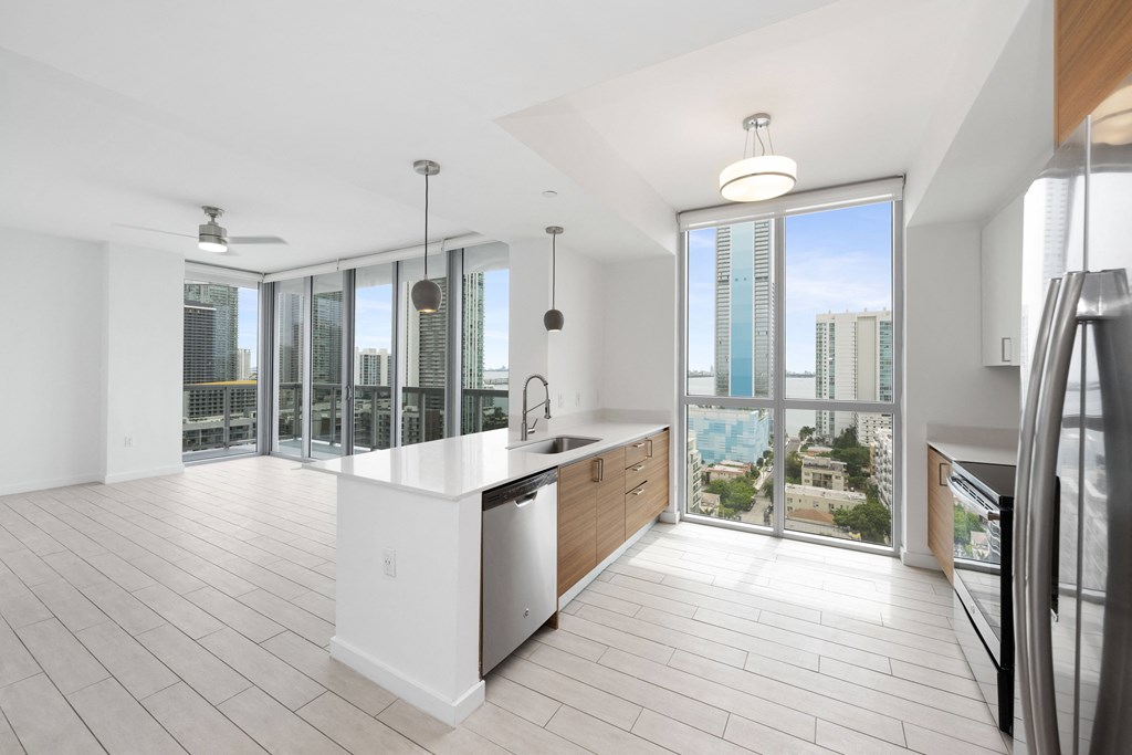 a kitchen and living room with a view of the city